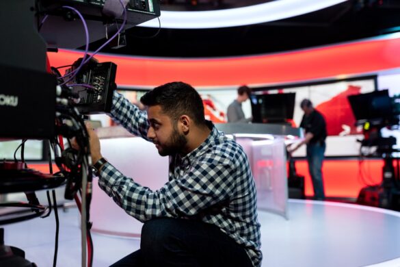 Male broadcast engineer works in studio